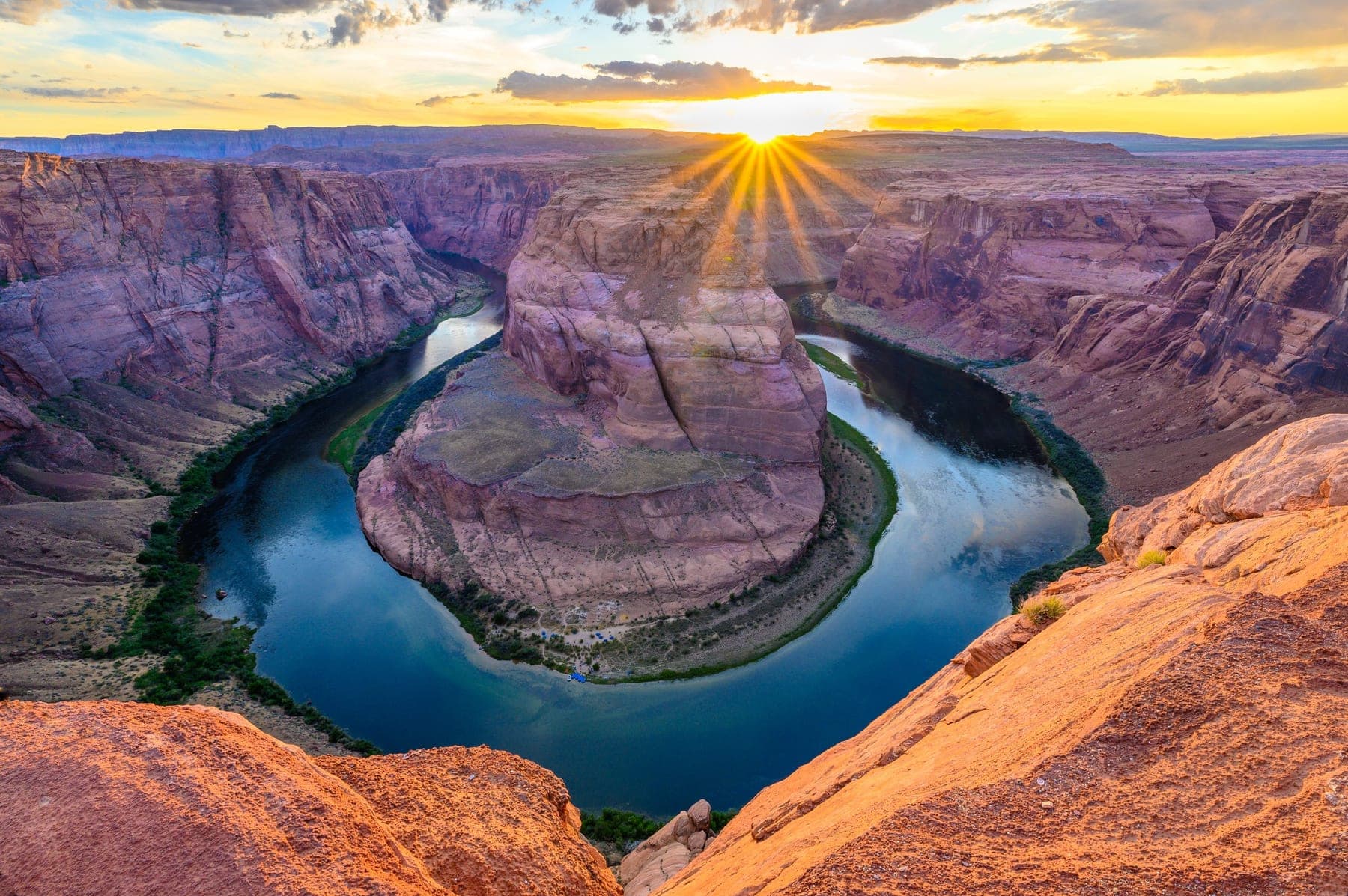 The Colorado River curving around the red sandstone of Horseshoe Bend from above